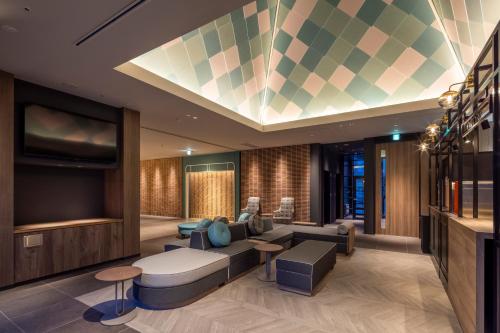 a living room with a couch and a tv at Tokyu Stay Hakodate Asaichi Akarinoyu in Hakodate
