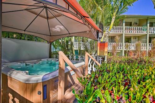 a hot tub with an umbrella in a yard at OUTSTANDING OCEANFRONT STUDIO - KONA ISLANDER INN CONDOS condo in Kailua-Kona