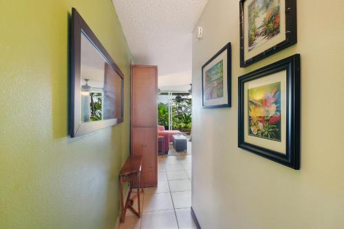 a hallway with three pictures on the wall at OUTSTANDING OCEANFRONT STUDIO - KONA ISLANDER INN CONDOS condo in Kailua-Kona