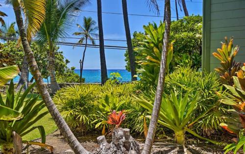 a tropical garden with palm trees and the ocean at OUTSTANDING OCEANFRONT STUDIO - KONA ISLANDER INN CONDOS condo in Kailua-Kona