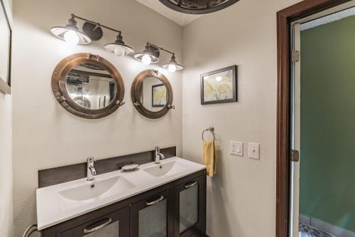 a bathroom with a sink and two mirrors at OUTSTANDING OCEANFRONT STUDIO - KONA ISLANDER INN CONDOS condo in Kailua-Kona