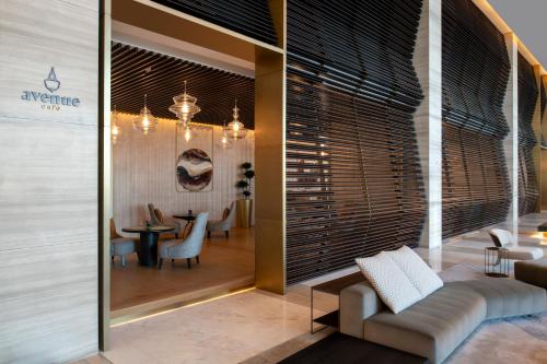 a lobby of a hotel with a table and chairs at Steigenberger Hotel Doha in Doha
