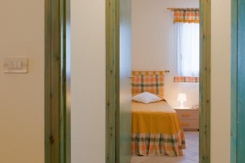 a small bedroom with a bed and a window at Blue Sea - Villa Aquilone by Wonderful Italy in Ostuni