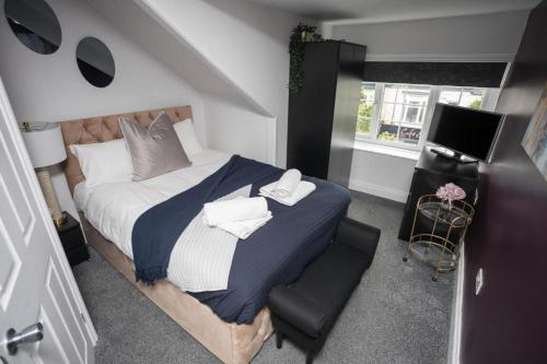 a bedroom with a large bed and a window at Comfy-Stays - Ocean Road in South Shields
