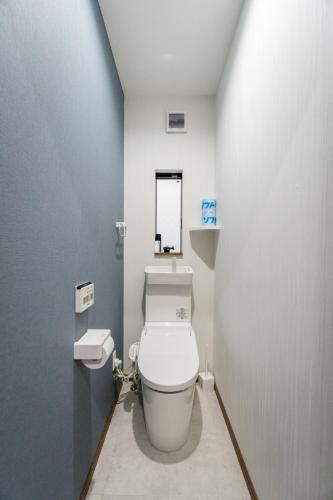 a bathroom with a white toilet and a sink at HANASTAY花渓居 · 海（UMI) in Osaka