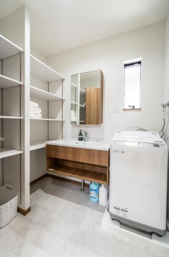 a bathroom with a sink and a mirror at HANASTAY花渓居 · 海（UMI) in Osaka