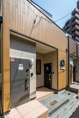 a building with its doors open on a street at HANASTAY花渓居 · 海（UMI) in Osaka