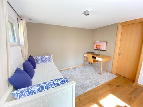 a small bedroom with a bed and a desk at 3-Schlafzimmer Chalet Eichhorn****, Saas Fee 1800m in Saas-Fee