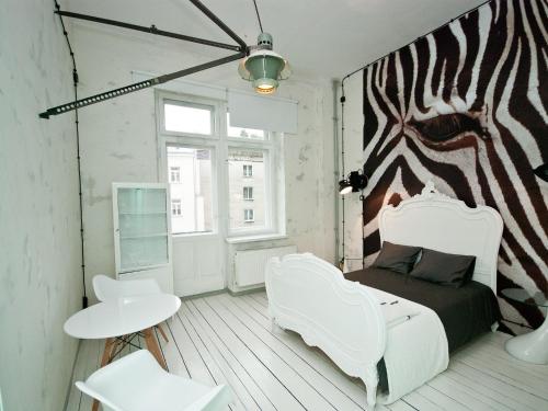 a bedroom with a zebra mural on the wall at Loft Sen Pszczoły in Warsaw