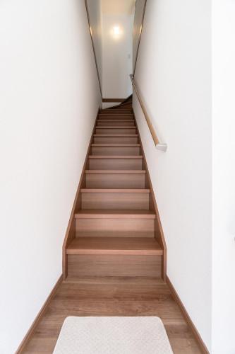 a staircase in a house with a rug at HANASTAY花渓居 · 海（UMI) in Osaka