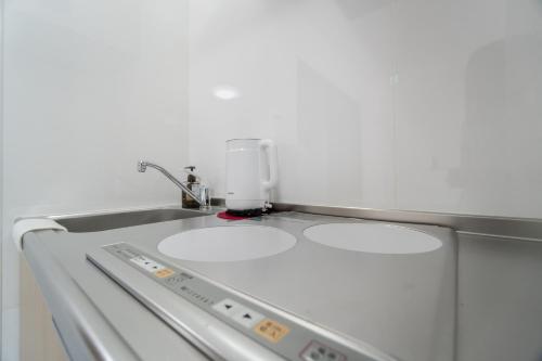 a kitchen counter with two white sinks in it at HANASTAY花渓居 · 海（UMI) in Osaka