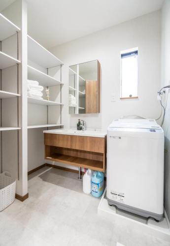 a bathroom with a sink and a mirror at HANASTAY花渓居 · 海（UMI) in Osaka