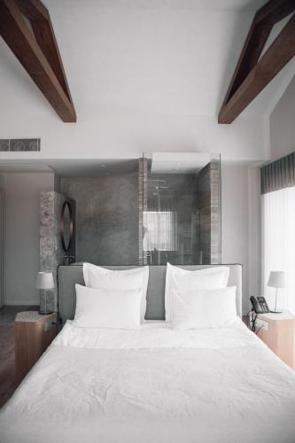 a bedroom with a large white bed with white pillows at Teruar Urla in Urla