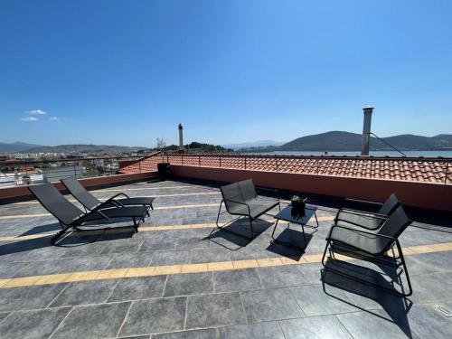 a group of chairs and a table on a roof at Apollon Loft in Chalkida