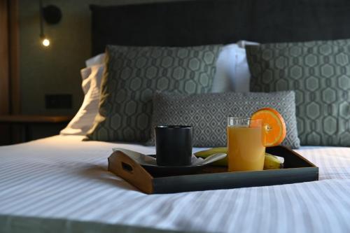 a tray of food and drinks on a bed at Apollon Loft in Chalkida