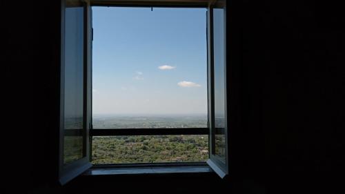 an open window with a view of a city at Borgo 63 Medieval House in Montecelio