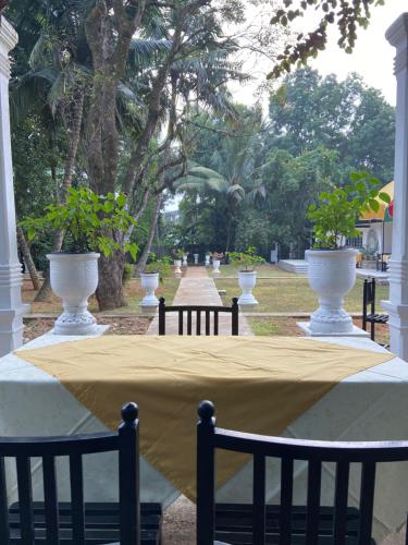 a table with a yellow table cloth on it at Clover Grange Home Stay in Matale