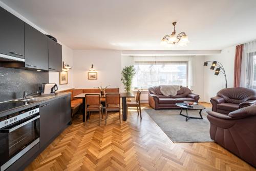 a kitchen and living room with a couch and a table at Haus Kindler in Radstadt
