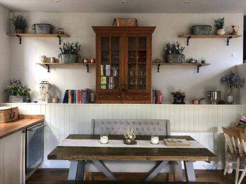 a table and a chair in a kitchen at Chefs cottage in Kenmore