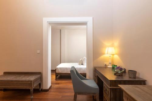 a bedroom with a bed and a desk and a chair at Heritage Boutique by Seven Angels in Kandy