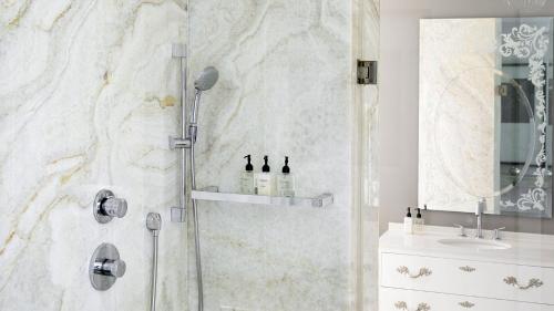 a bathroom with a shower and a sink at Queen Victoria Hotel by NEWMARK in Cape Town