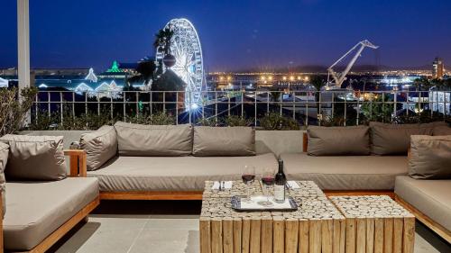 a living room with a couch and a ferris wheel at Queen Victoria Hotel by NEWMARK in Cape Town