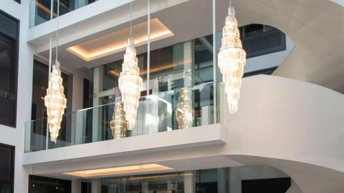 a cluster of lights hanging from a building at Queen Victoria Hotel by NEWMARK in Cape Town