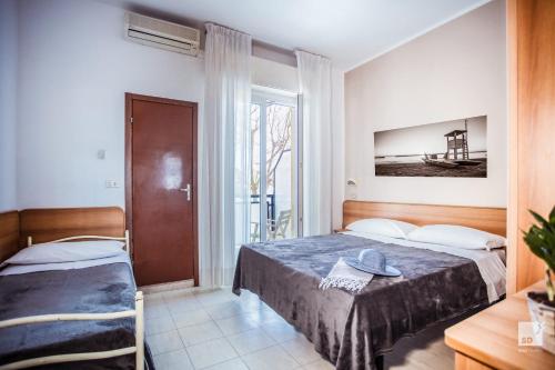 מיטה או מיטות בחדר ב-Hotel Fattori Mare