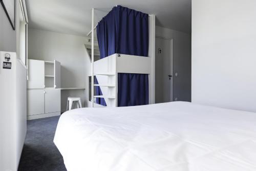 a bedroom with a bed and a dresser at The People - Tours in Tours