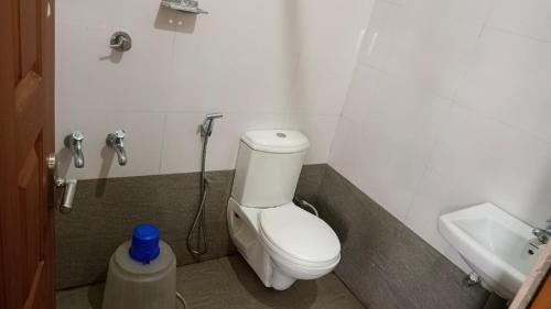 a bathroom with a toilet and a sink at Retaj Residency in Ernakulam