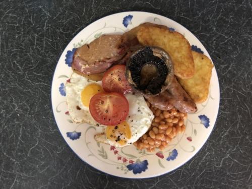 a plate of breakfast food on a table at Westbury Lodge in Shanklin