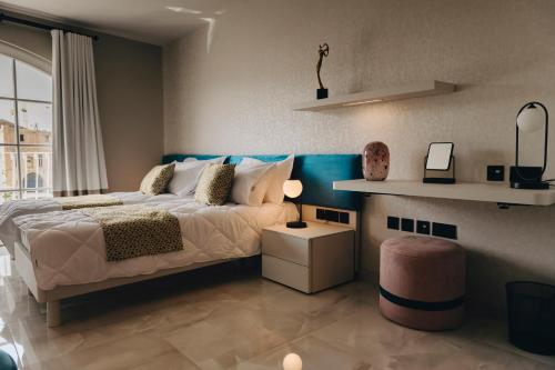 a bedroom with a large bed and a table at Dock 1 Boutique Hotel in Cospicua