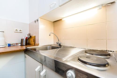 a kitchen with a sink and a counter top at City Apartment Köln in Cologne