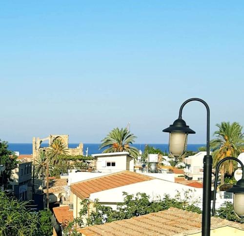 a view of a city with palm trees and a street light at Malia Holiday Let in Famagusta