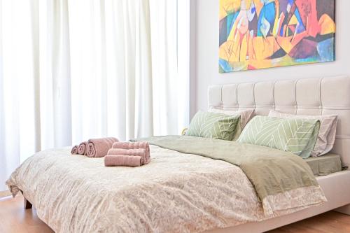 a bedroom with a large bed with a pink blanket at Modern flat in the heart of Port of Piraeus (D2) in Piraeus