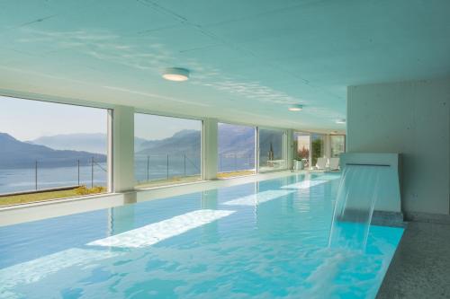 a swimming pool with a view of the ocean at Valarin Luxury Apartments & Wellness, Vercana by Rent All Como in Vercana