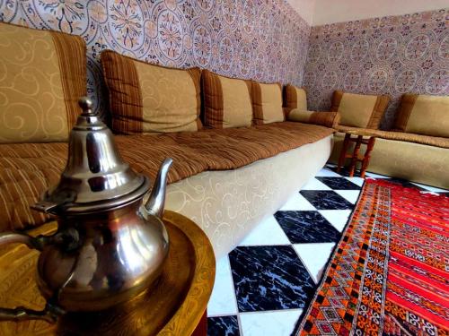 a living room with a couch and a table at Riad Nour Resorts-Riad Nour Travel in Marrakech