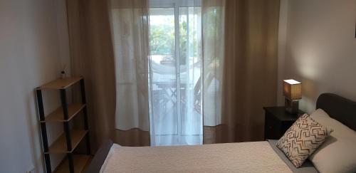 a bedroom with a bed and a window with curtains at FIND Your Space Casa no Campo - Paderne - Albufeira - Piscina Privada - Aquecida a pedido in Paderne