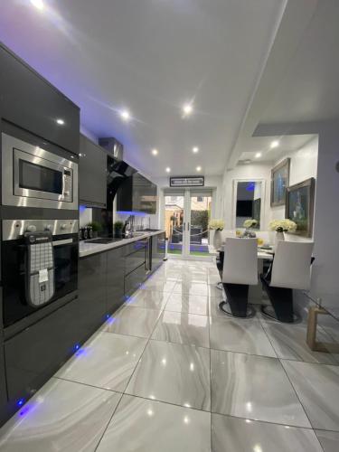 a large kitchen with a dining area and a table at NEW…THE HOTTUB HOUSE BLACKPOOL PLEASURE BEACH in Blackpool