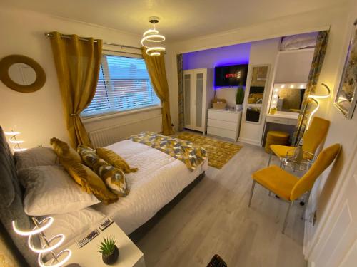 a bedroom with a large bed and a table at NEW…THE HOTTUB HOUSE BLACKPOOL PLEASURE BEACH in Blackpool