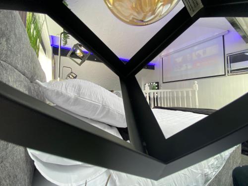 a view of a bed in a room with a window at NEW…THE HOTTUB HOUSE BLACKPOOL PLEASURE BEACH in Blackpool