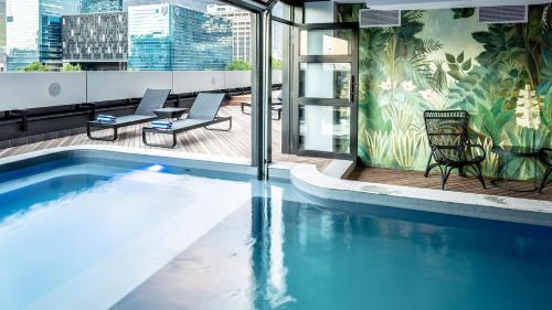 a swimming pool on the roof of a building at The Onyx Apartment Hotel by NEWMARK in Cape Town