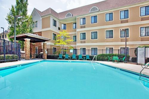 a swimming pool in front of a building at Sonesta ES Suites Atlanta Alpharetta Avalon in Alpharetta