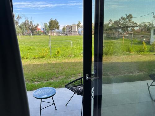 a view of a soccer field through a sliding glass door at V luxury Suites in Pefkohori