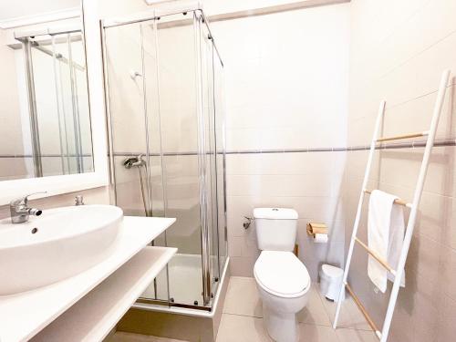 a bathroom with a toilet and a sink and a shower at CC - Casa da Costa in Costa Nova