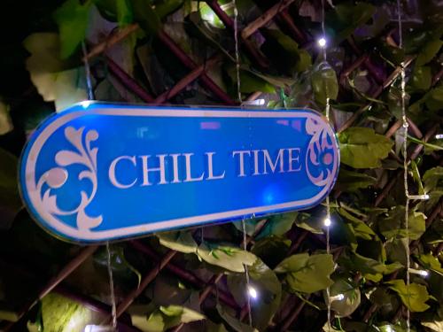 a sign that reads chill time hanging from a bush at NEW…THE HOTTUB HOUSE BLACKPOOL PLEASURE BEACH in Blackpool