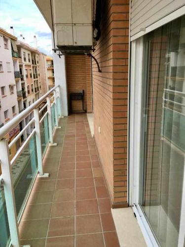 a balcony of a building with a window and a walkway at Chicflat Avenida España. Ideal para familias in Estepona
