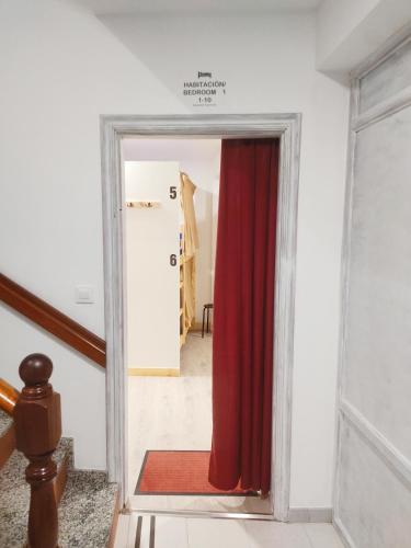 a door with a red curtain in a room at Albergue Santos in Santiago de Compostela