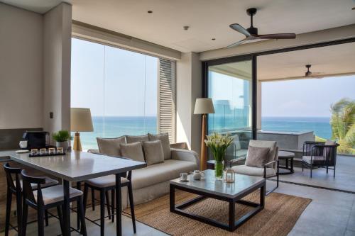 un salon avec un canapé et une table dans l'établissement Crystal Sands Hikkaduwa, à Hikkaduwa