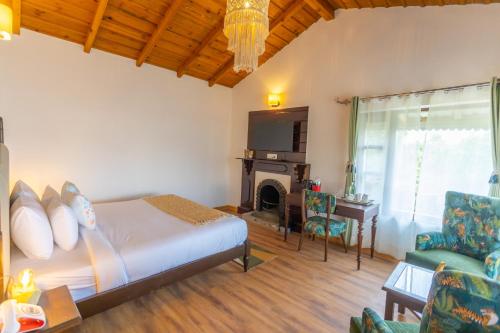 a bedroom with a bed and a fireplace at Seclude Ramgarh Willows in Rāmgarh